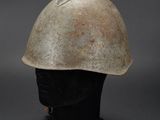an old helmet is sitting on top of a black base