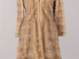 an image of a woman ' s fur coat on a mannequin stand
