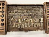 an old type of printing on display in a display case