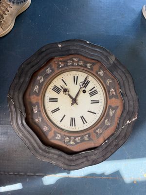 a clock that is on the wall next to a pair of shoes