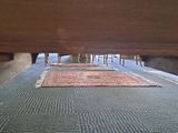 a carpet on the floor under a bed