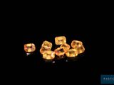 a group of yellow sapphires sitting on top of a black surface