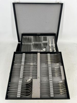 a black case with silverware in it on a white surface
