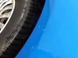 a close up of a tire on a blue car