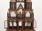 a wooden model of a castle sitting on top of a table