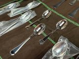 many spoons and spoon spoons laid out on a table