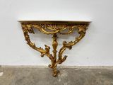 an image of a gold console table with a marble top