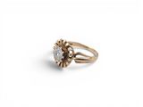 a close up of a gold ring with a diamond in the center