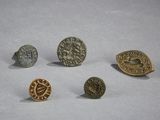 four different types of metal buttons on a white surface