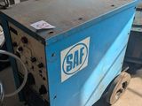 a blue machine that is sitting in a garage