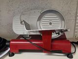 a red machine on top of a shelf in a kitchen