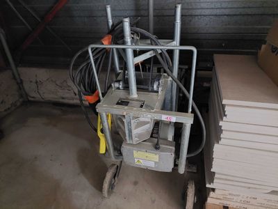 a cart with a bunch of wires on it in a garage