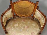 an image of a chair with a cane back and floral upholstered seat