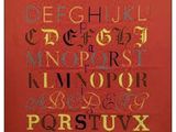 une image représentant un alphabet au point de croix sur fond rouge