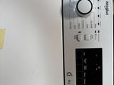 a white washing machine with a button on it