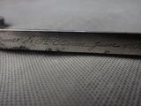 a close up of a metal object with writing on it
