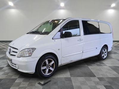 a picture of a white van parked on a checkered floor