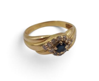a close up of a gold ring with a blue stone