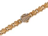 a close up of a gold and diamond bracelet on a white background