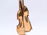a gold sculpture of a violin and a cello on a marble base