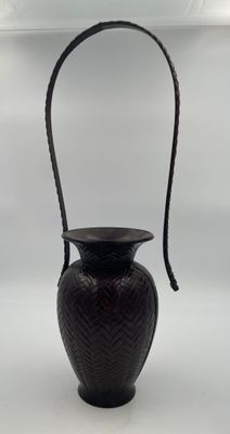 an image of a black vase with a handle on a white background