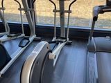 a row of stationary exercise bikes in a gym