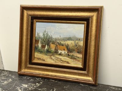 peinture à l'huile encadrée représentant une scène rurale avec un village au loin
