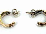 two tone gold and silver hoop earrings on a white background