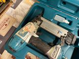 a blue box with a stapler and a stapler in it