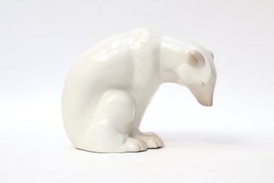 a white bear figurine sitting on a white surface
