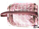 a pink purse that is sitting on a white surface