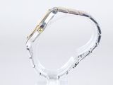 a close up of a watch on a clear surface with a white background