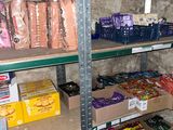 a shelf full of food and snacks in a store