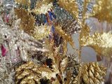 a potted plant that has gold and silver decorations in it