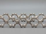 a group of silver figurines that are standing in a row