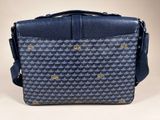 a close up of a blue and black bag on a white surface