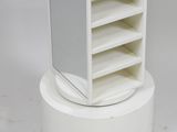 a white tower with a mirror on top of it