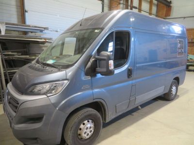 a blue van that is parked in a garage