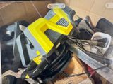 a yellow and black machine sitting on top of a pile of boxes