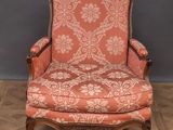 an old chair with a red upholstered upholstered seat