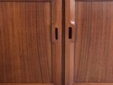 a close up of a wooden cabinet with two doors