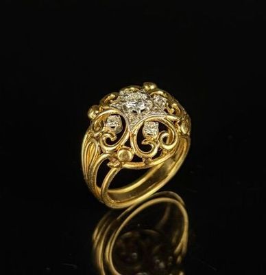 a gold ring with diamonds on a black surface