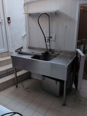 a kitchen with a sink and a stove in it