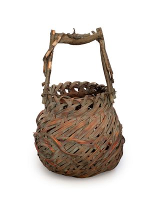 a wicker basket with a wooden handle on a white background