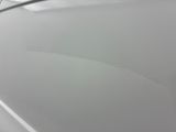 someone is peeling the paint off of a car ' s hood
