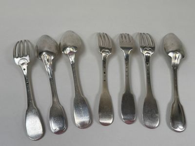 six forks and spoons are lined up on a white surface