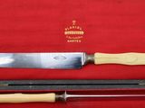 a knife in a case with a wooden handle