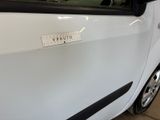 a small white car with a sticker on the side of it