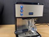 a close up of a coffee machine on a wooden table