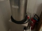 an image of a stainless steel pot on a stand in a bathroom